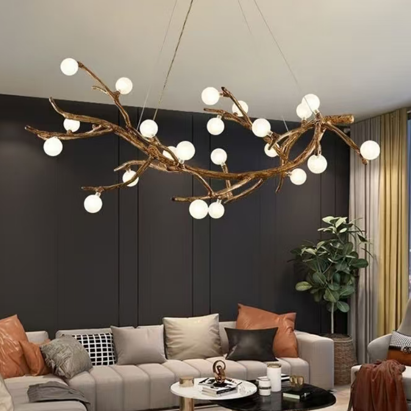 Gold branch-style chandelier with many white globe bulbs and an overhead round ceiling mount