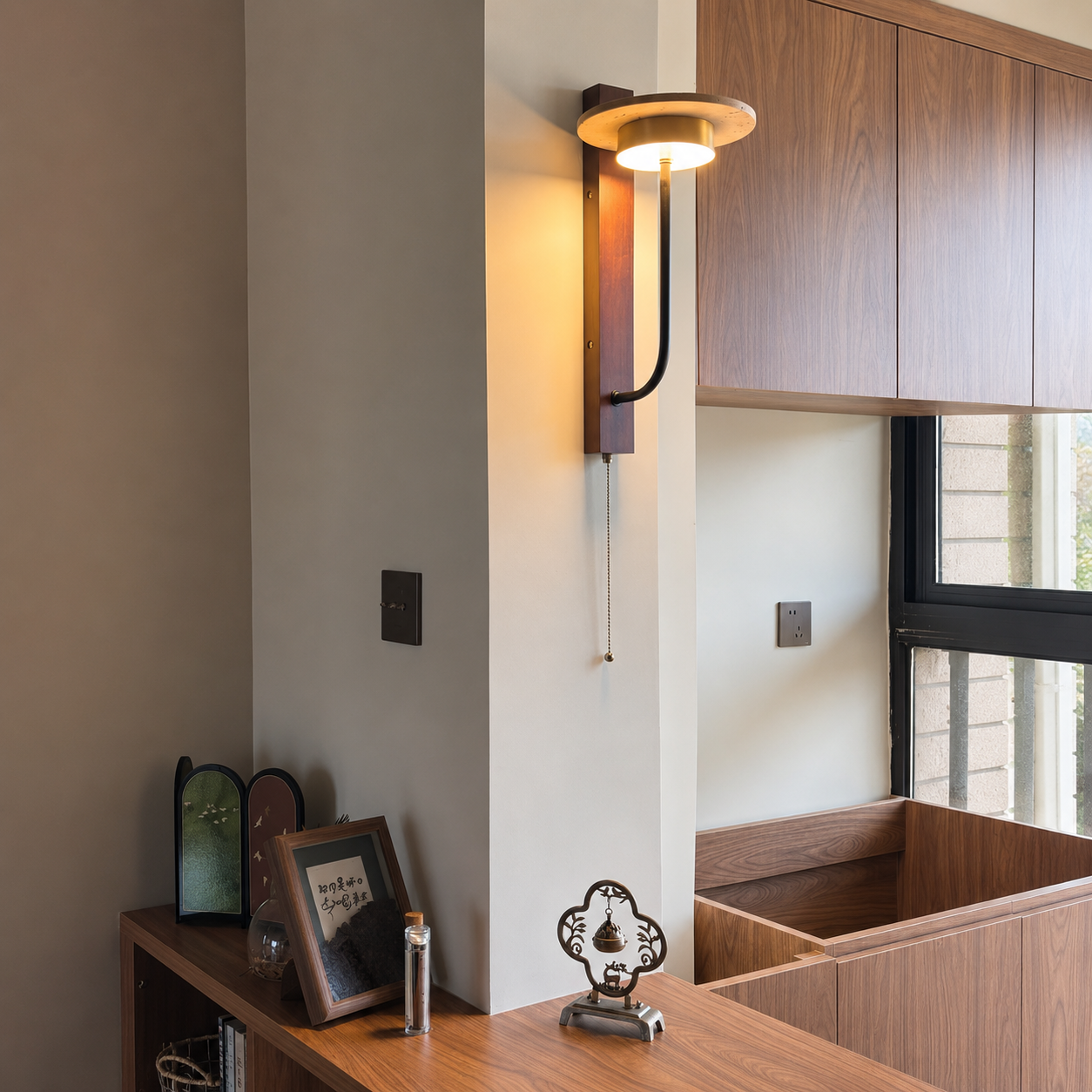 Wood wall sconce with halo shade, curved metal arm, and long pull chain