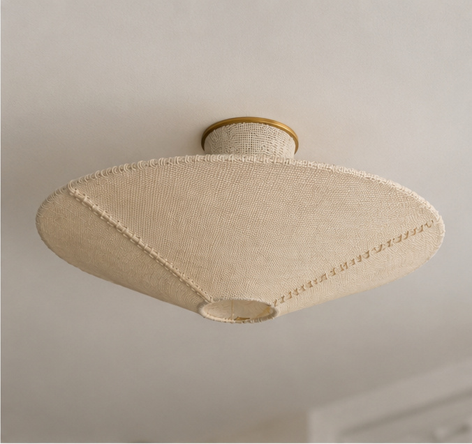 Beige woven flush mount ceiling light with stitched trim and gold ceiling plate