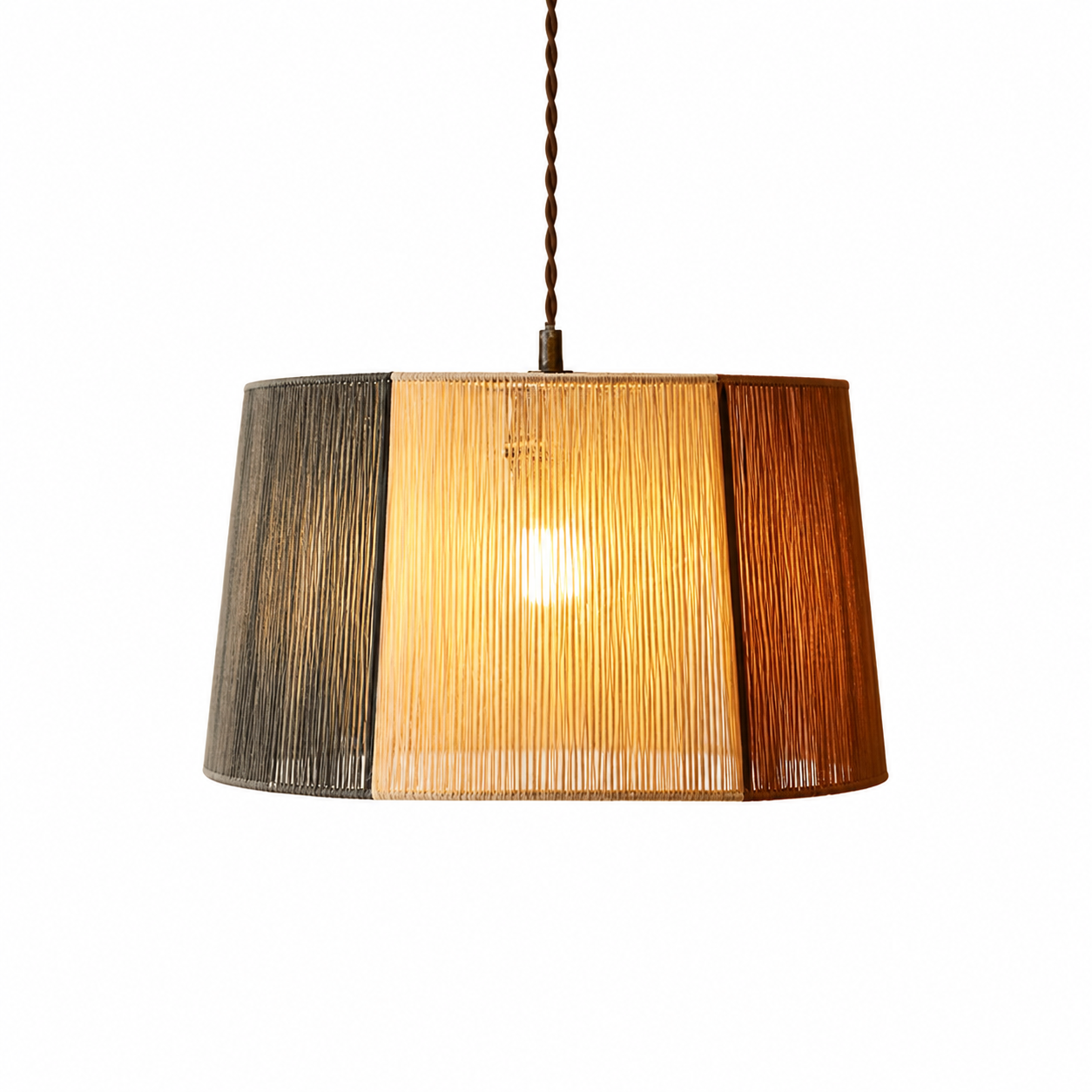 Woven pendant lamp shade with vertical two-tone panels and hanging cord, warm amber glow