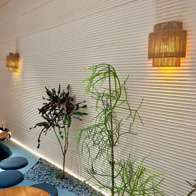 Woven rope drum wall sconce with warm glow and cylindrical ribbed woven shade