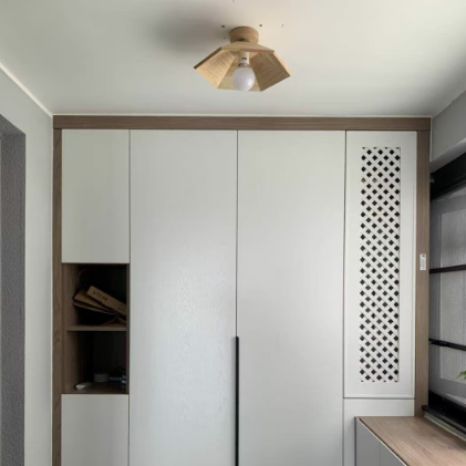 Light wood flush-mount ceiling light with faceted stacked shade and frosted bulb globe
