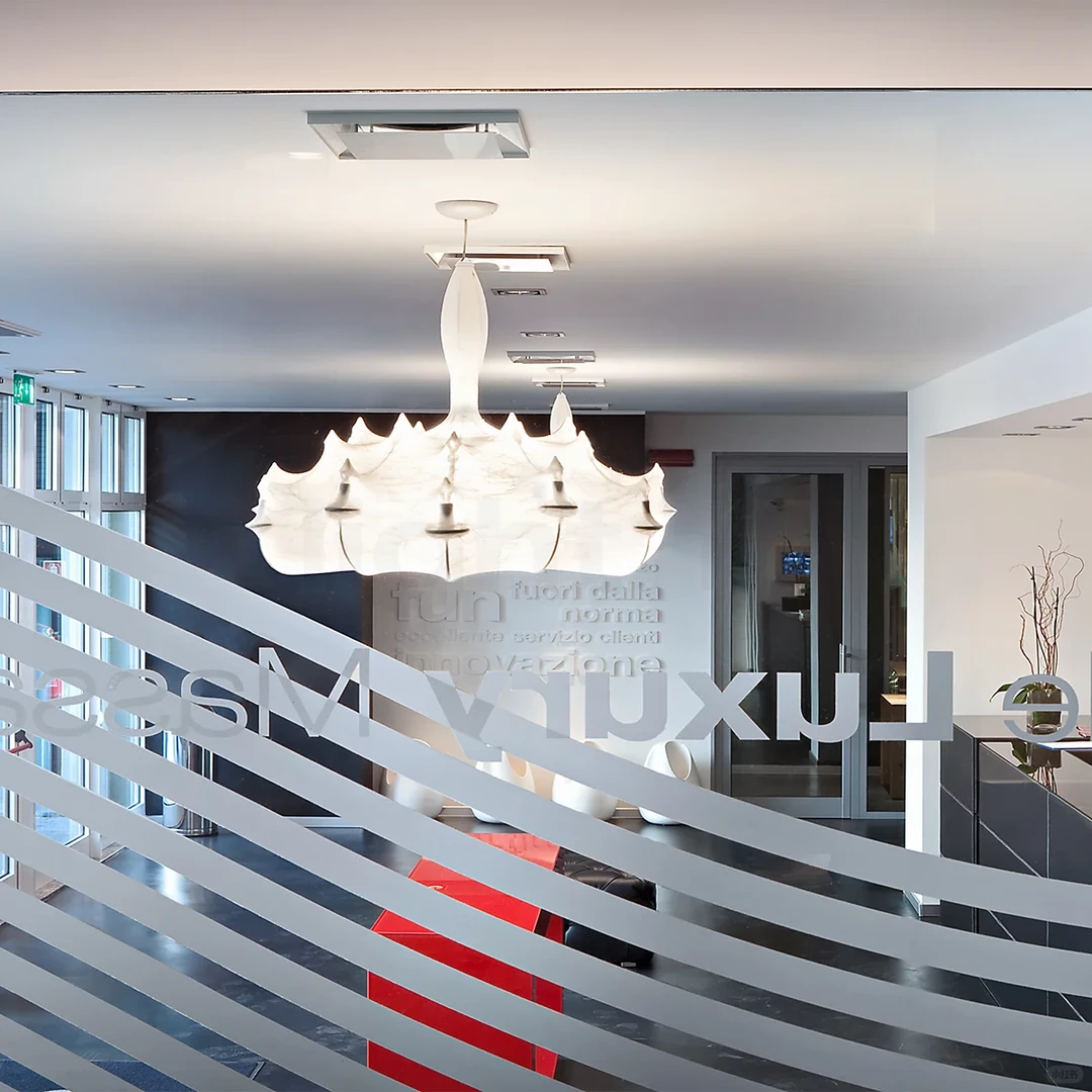 Silk petal chandelier with multiple white scalloped shades hanging from a ceiling mount
