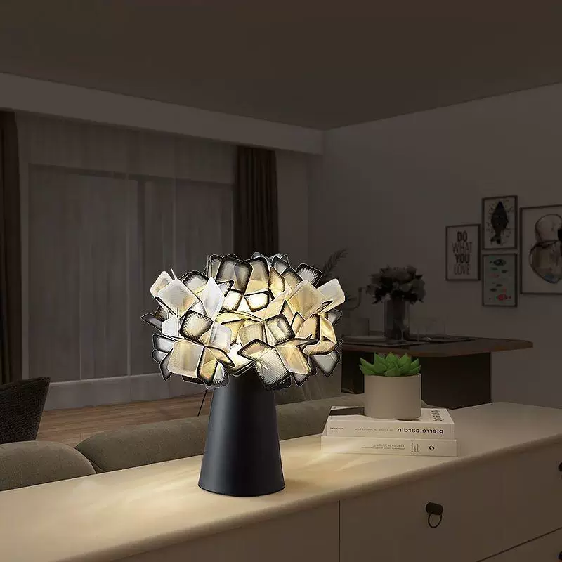 Black geometric blossom table lamp with glowing white cube shade