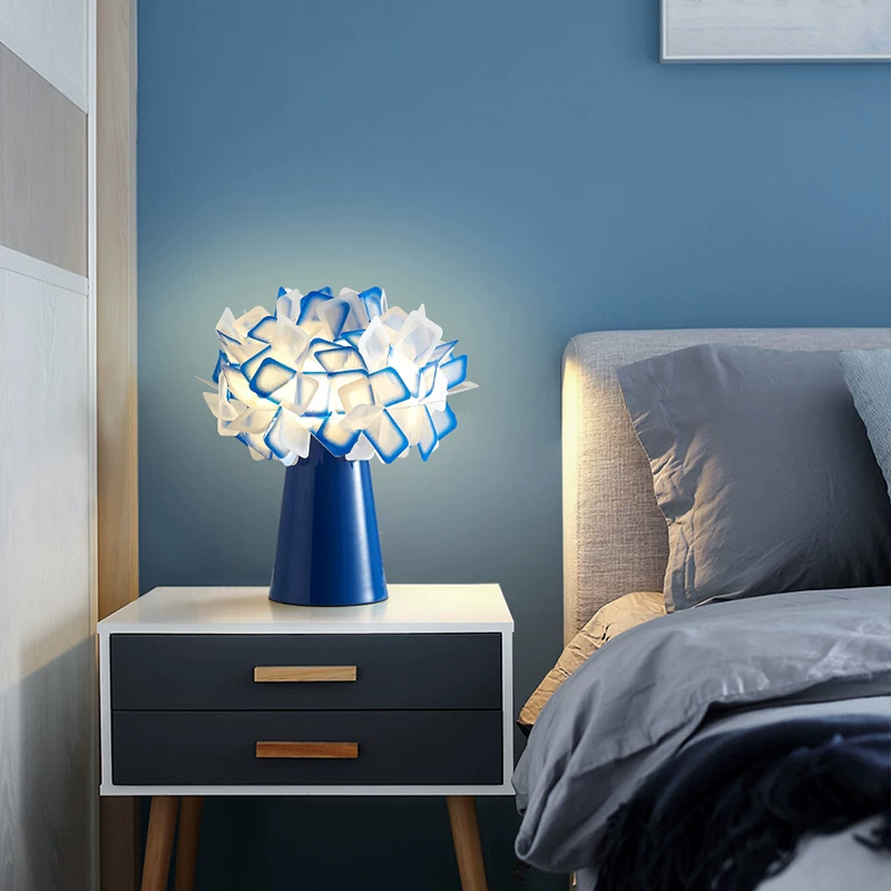 Geometric blossom table lamp with blue base and cool white geometric cube shade.