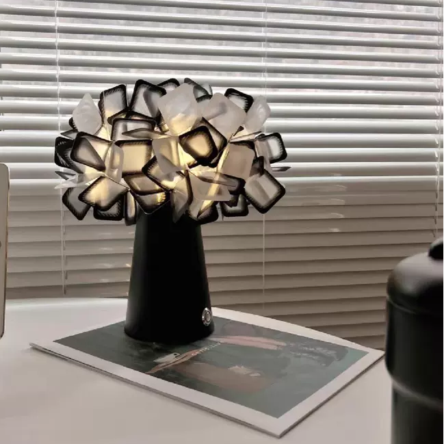 Black geometric blossom table lamp with white-and-black cube shade