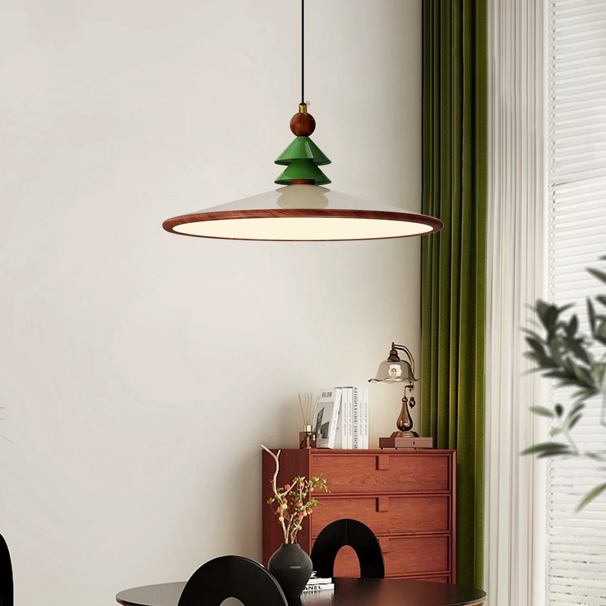 Green pine-topped cone pendant light with brass ring shade and brown bead finial.