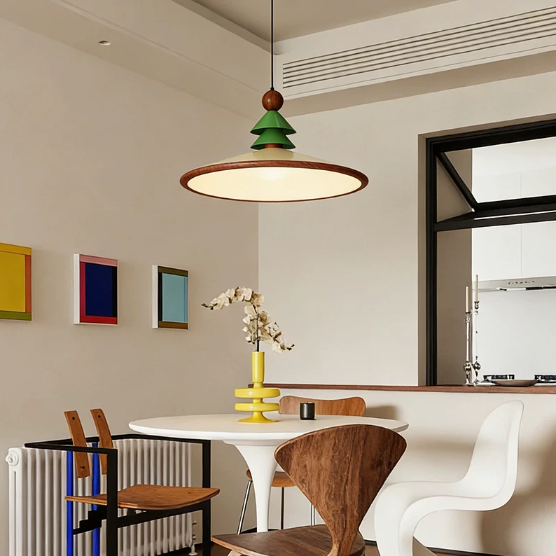 Green pine cone pendant light with brass ring shade and exposed brown finial.