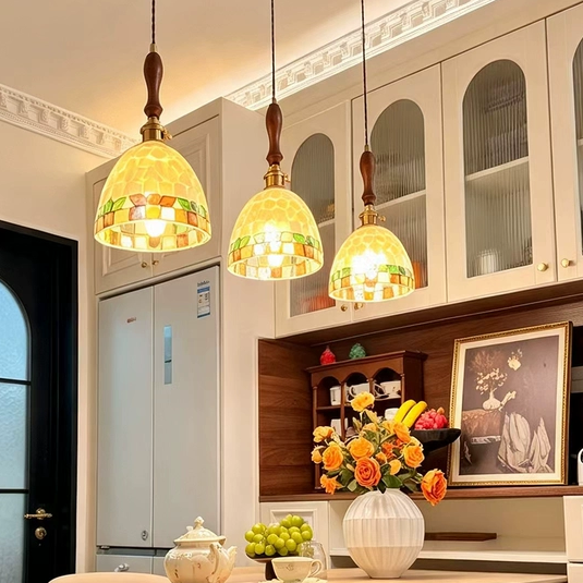 Group of mini pendant lights with mosaic glass shades and antique brass stems