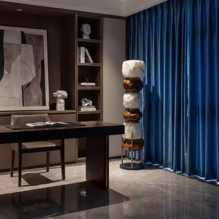 Stacked resin totem floor lamp with glowing amber and white resin sections and round base