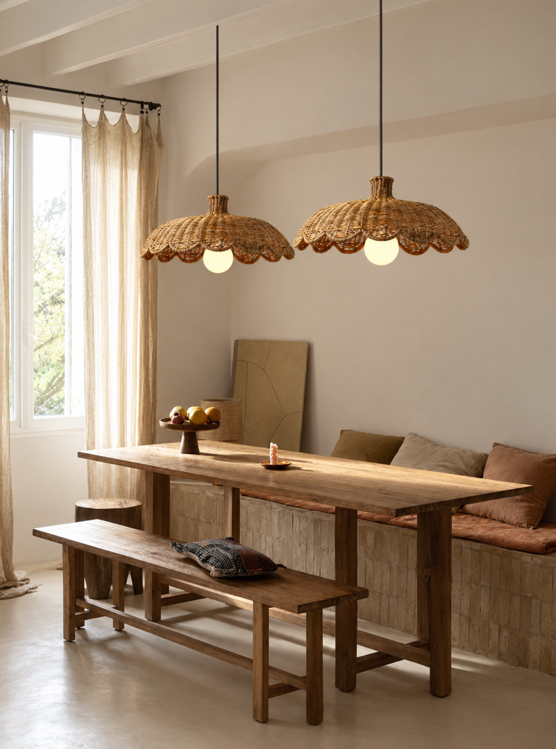 Caleta woven rattan pendant lights with two scalloped shades and lit bulbs
