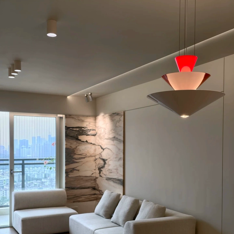 Tiered geometric cone pendant light with red top cone and layered white shades