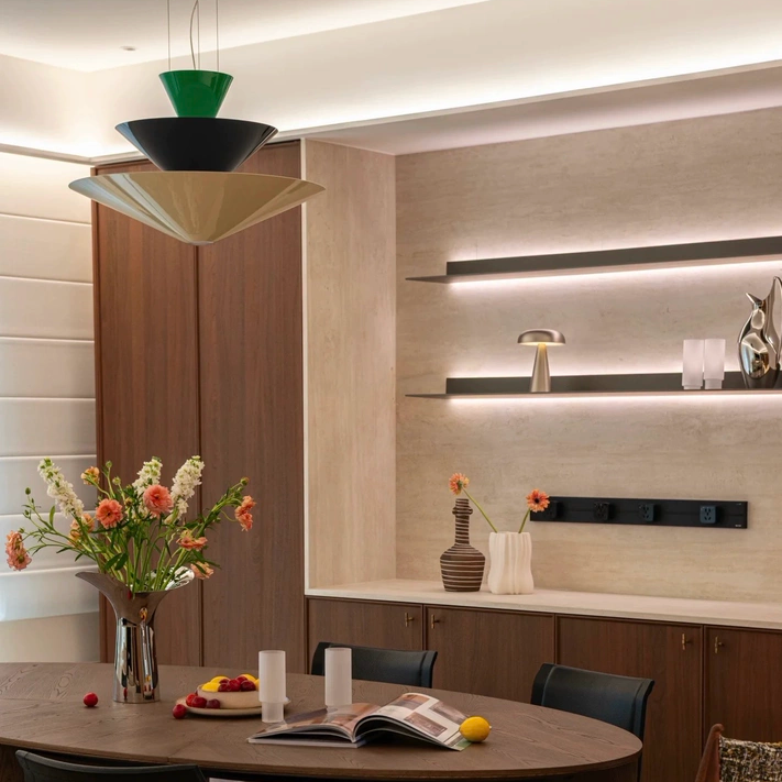 Tiered geometric cone pendant light with green top cone and black lower cones