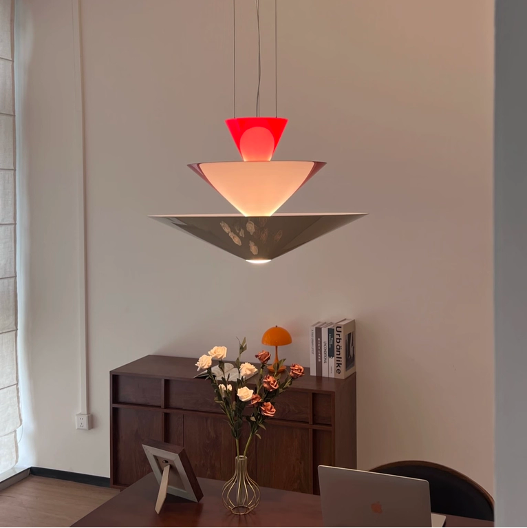 Tiered geometric cone pendant light with red top cone and warm illuminated tiers