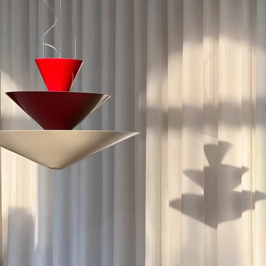 Red tiered cone pendant light with three stacked shades hanging from the ceiling
