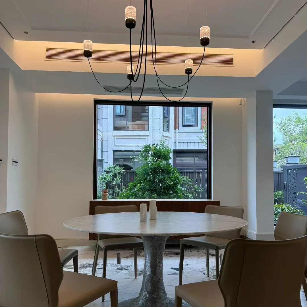 Catenary drape chandelier with black canopy, curved cords, and multiple fabric cylinder shades
