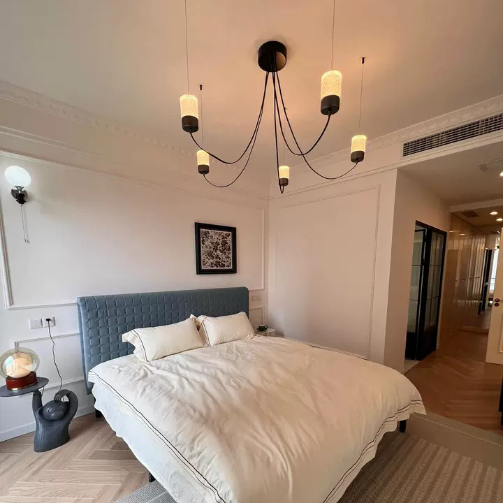 Catenary drape chandelier with black round canopy and several hanging fabric cylinder shades