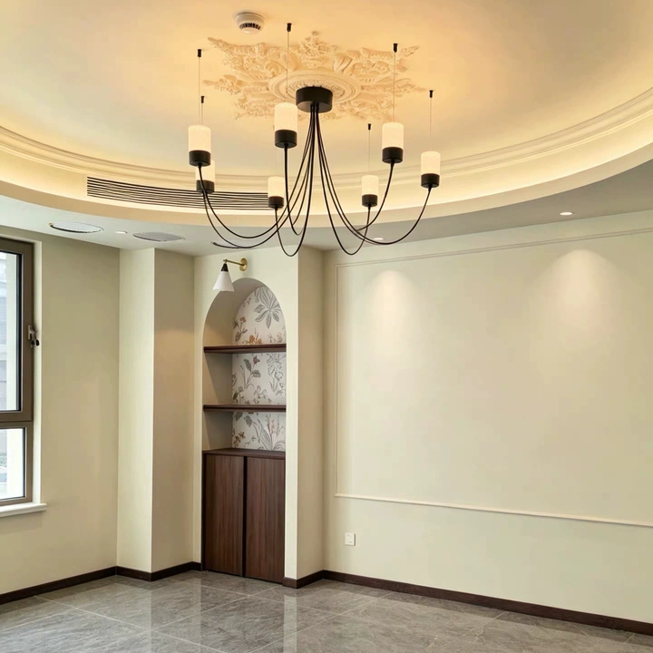 Catenary drape chandelier with black canopy and several downward fabric cylinder shades on cords