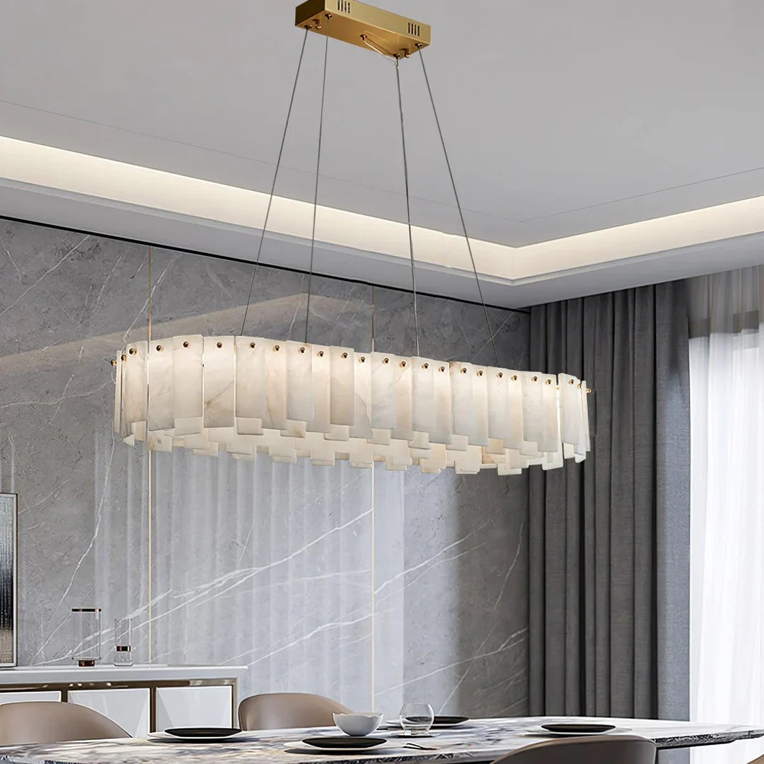 Oslo alabaster disc chandelier over a dining table with glowing layered alabaster panels