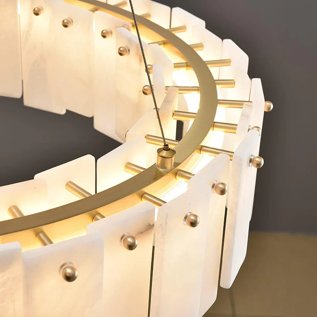 Oslo alabaster disc chandelier close-up of brass sockets and curved illuminated halo