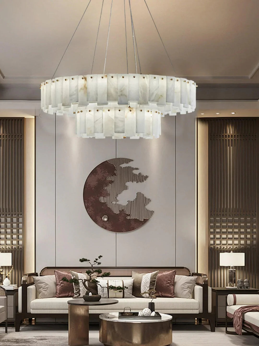 Oslo alabaster disc chandelier over a living room seating area with warm-lit alabaster panels