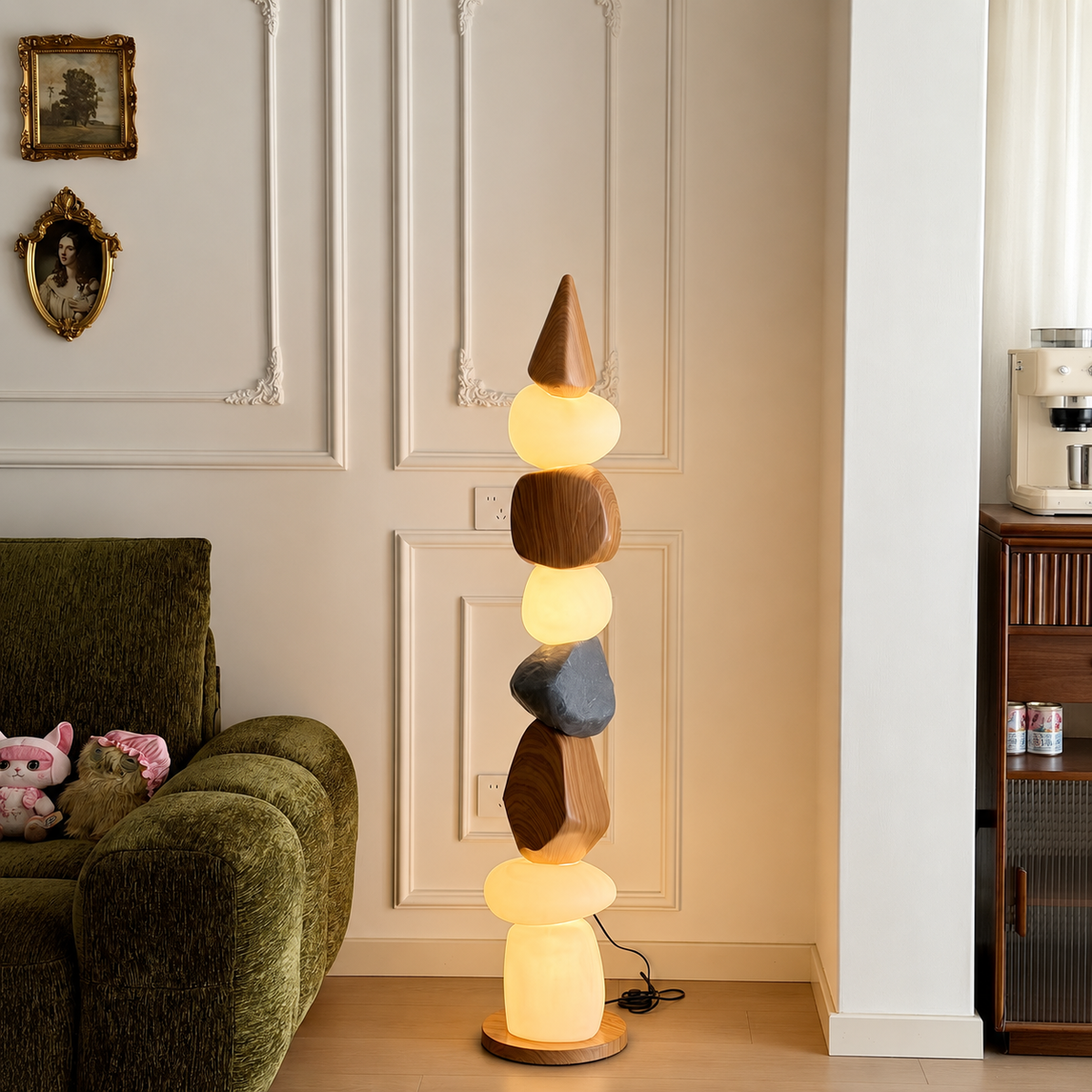 Pebble stack floor lamp with warm glowing stone pieces and circular wooden base