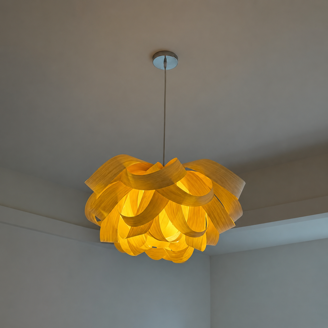 Wood veneer pendant light with layered ribbon-like shades, warm lit ceiling mount