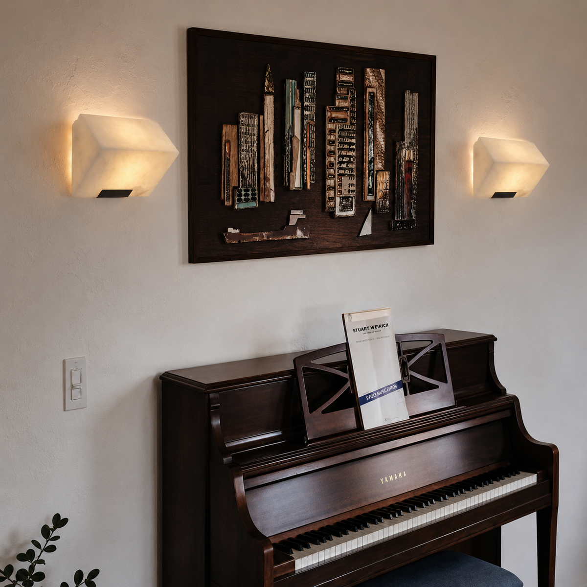 Alabaster cube wall sconce with glowing shade and dark metal base