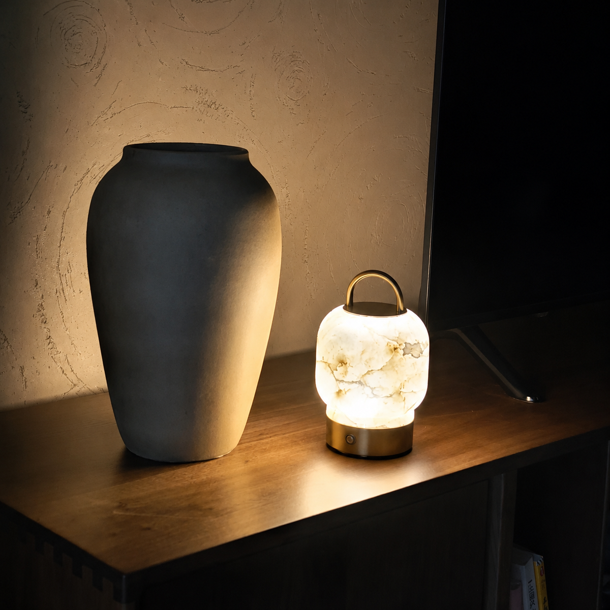 Cordless table lamp with cream alabaster lantern shade on brass base, arched handle