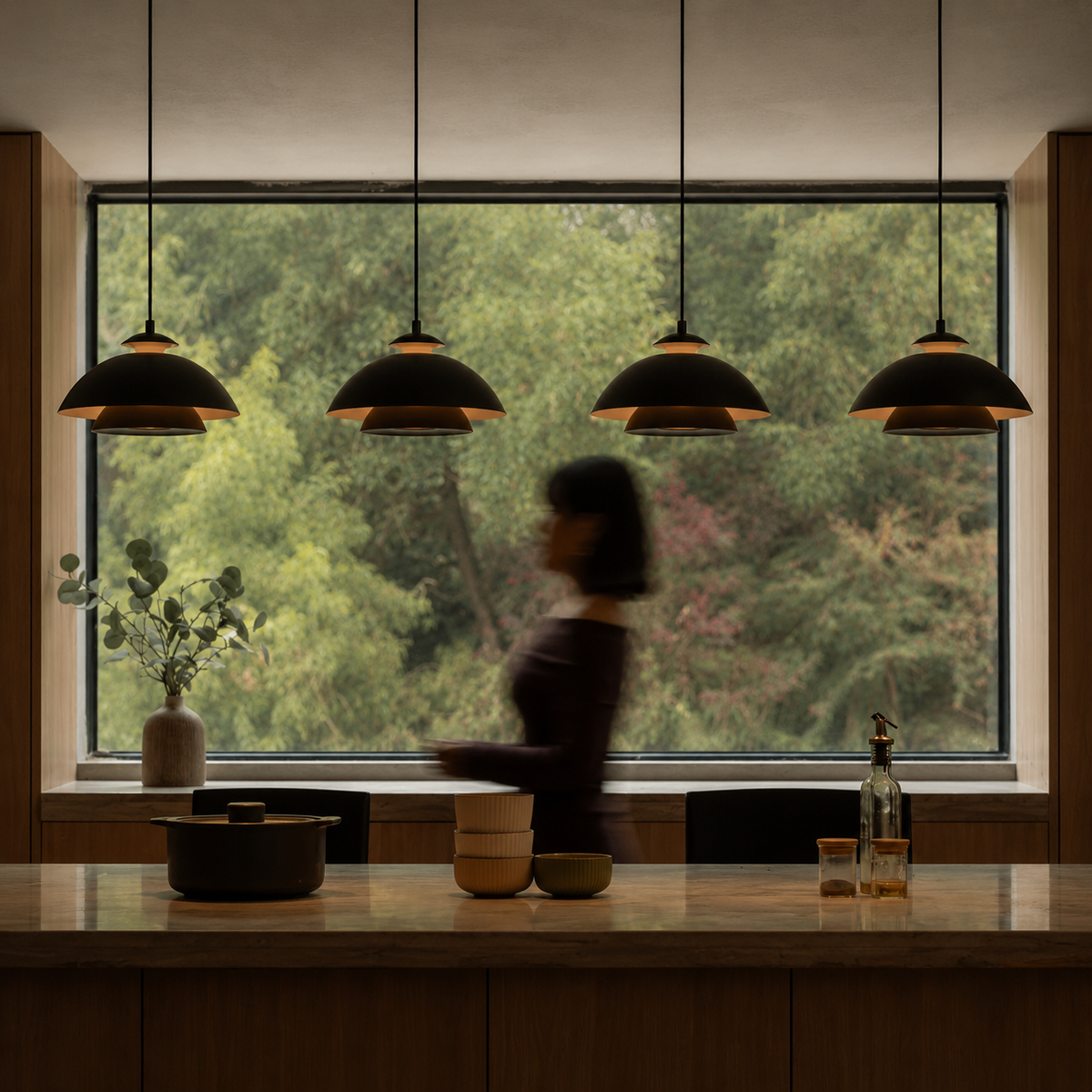Black dome pendant light row over window above countertop