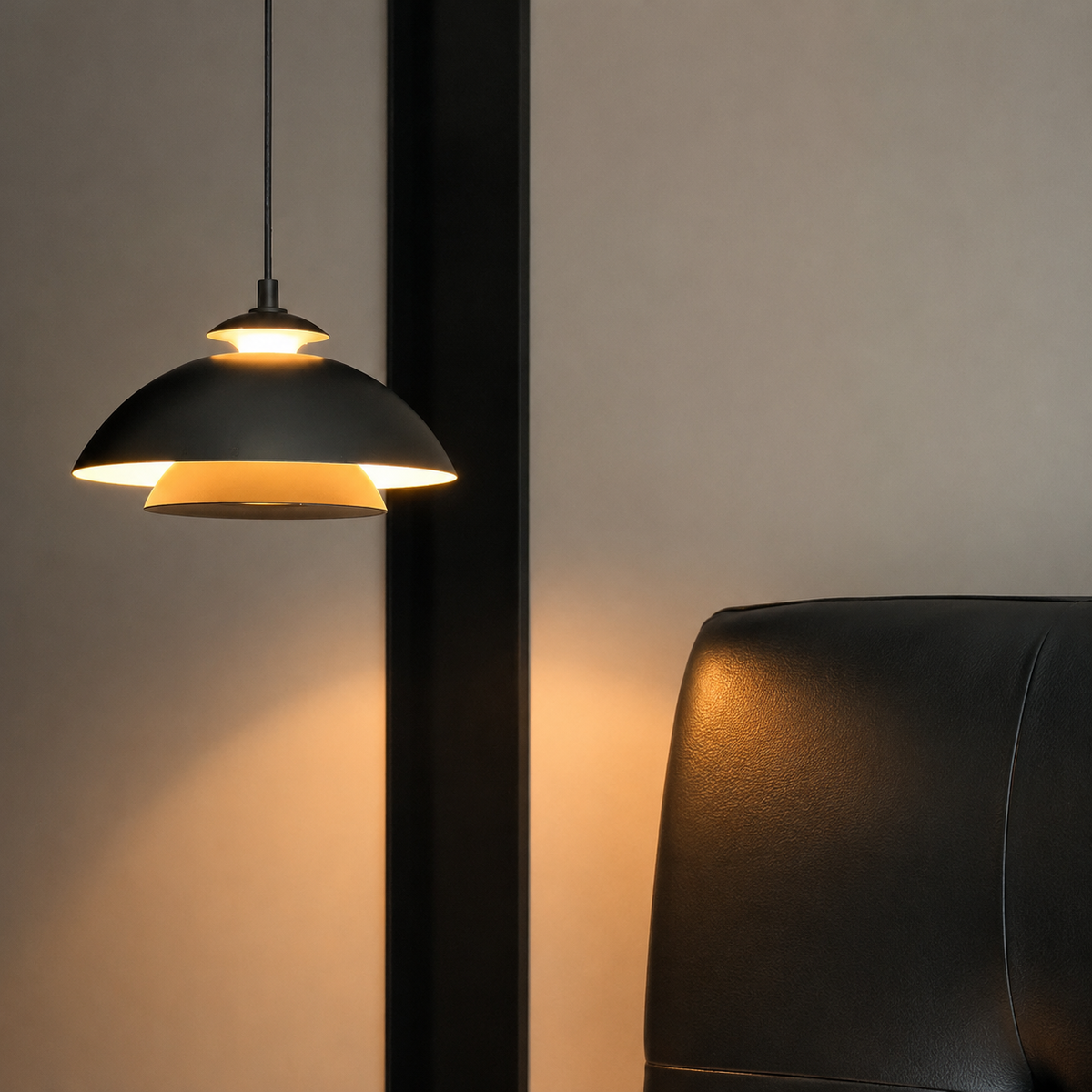 Single black dome pendant light with layered metal shade glowing warmly.