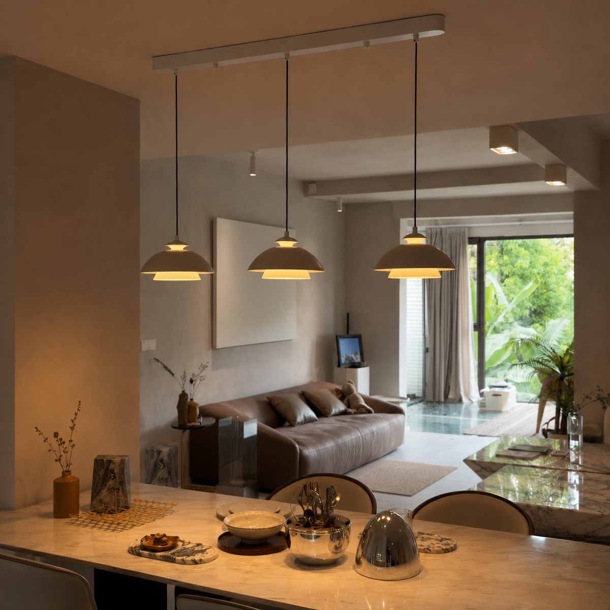 Black dome pendant light set with multiple shades above dining table
