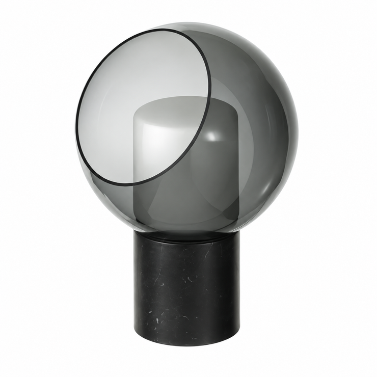 Dark glass globe table lamp with black cylindrical base and warm lit diffuser inside.
