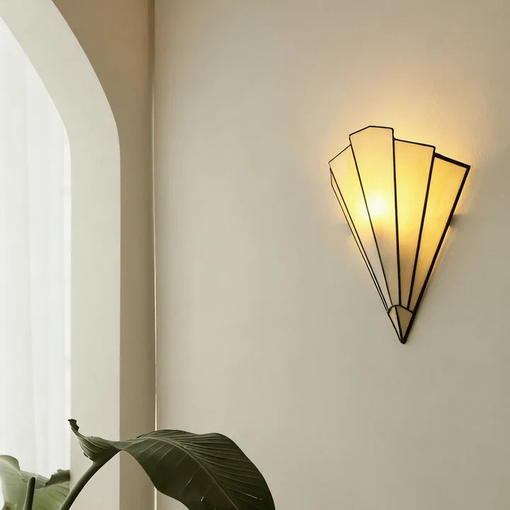 Fan-shaped wall sconce with white panels and matte black frame, warm light