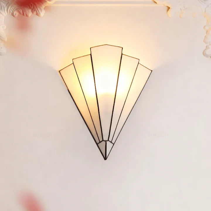 Fan-shaped wall sconce with white panels and matte black center support, lit glow