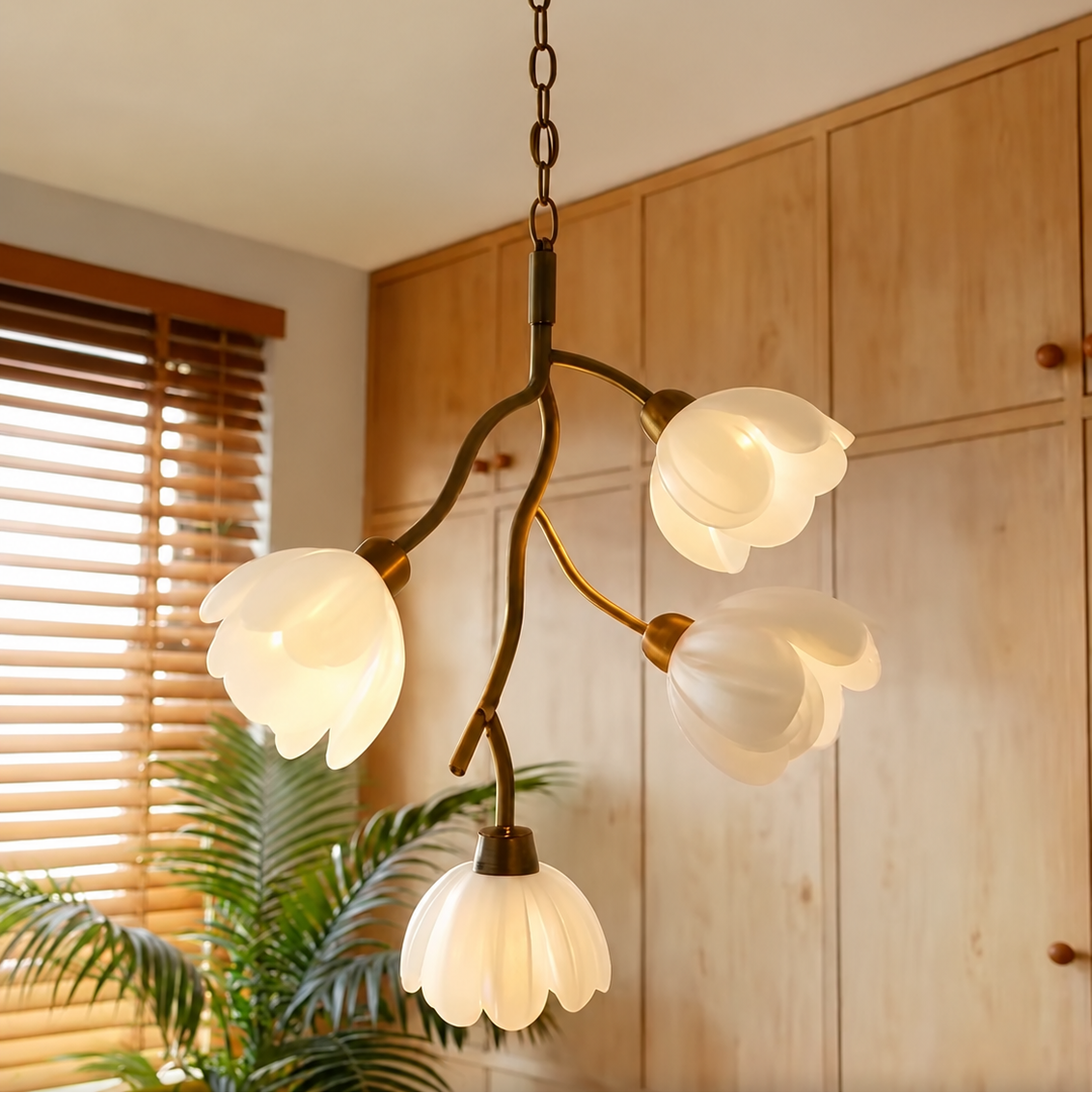 Gold floral branch chandelier with four white frosted flower shades in view