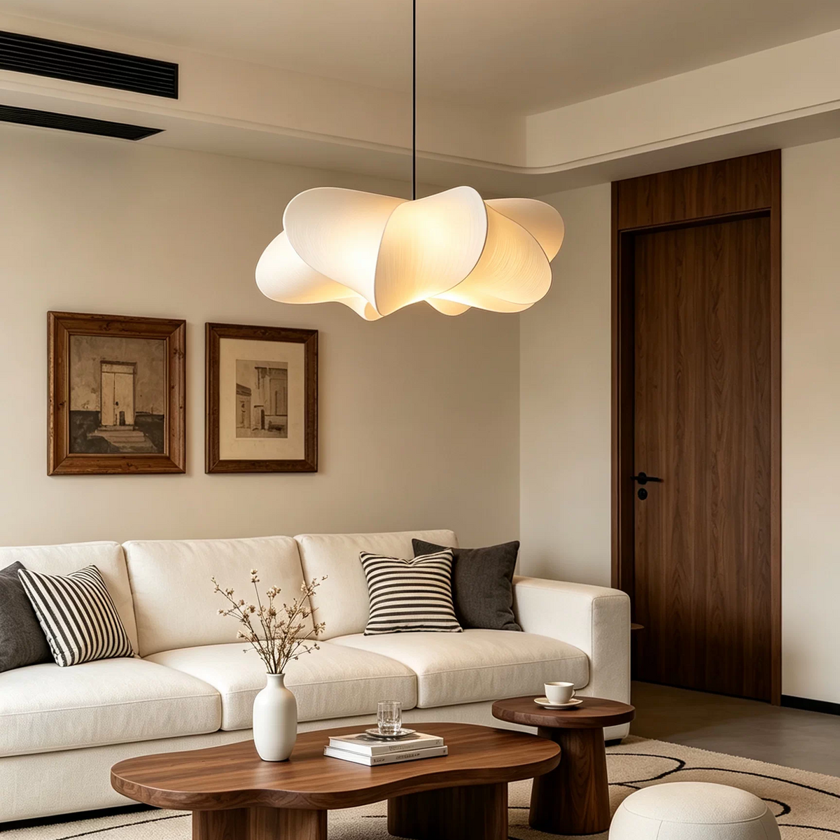Sculptural silk petal pendant light with beige fabric petals suspended over white sofa