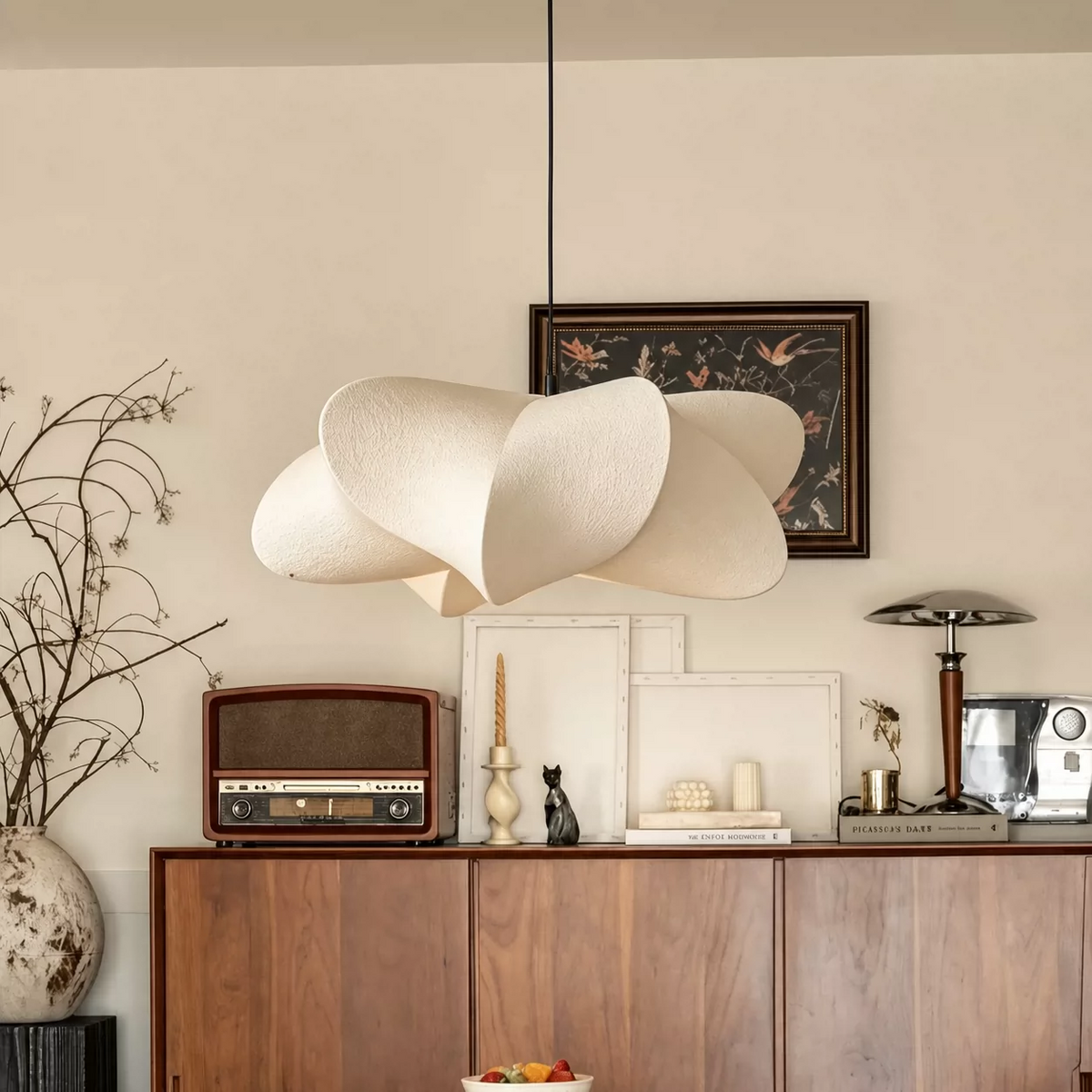 Cream layered silk petal pendant light with wide oval shades and central stem.