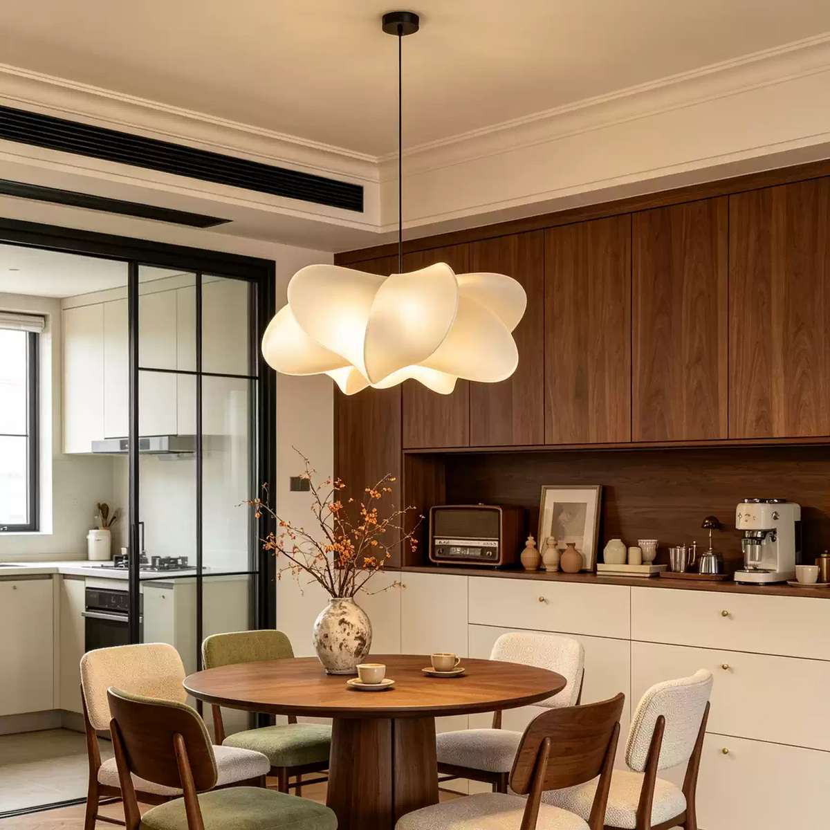 Cream silk petal pendant light with overlapping fabric shades suspended from black cord.