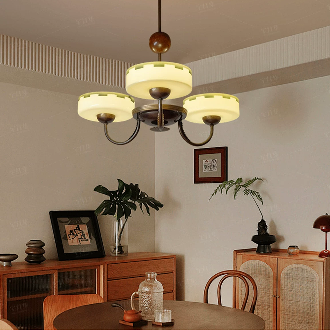 Bronze chandelier with cream opal glass shades and curved arms below the ceiling