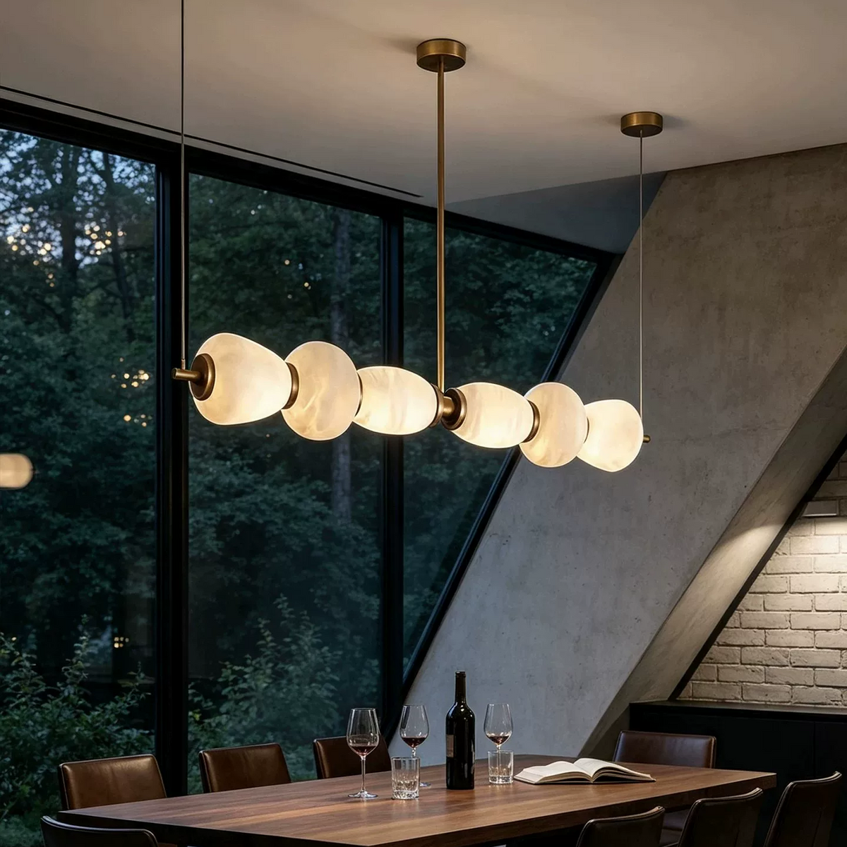 Linear chandelier with gold stem and frosted circular shades in a modern dining room