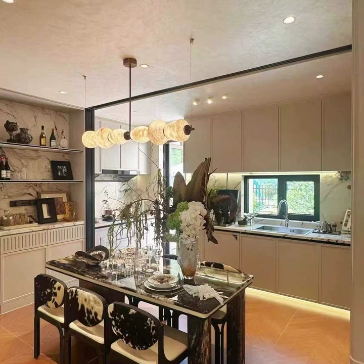 Linear chandelier with sculptural alabaster oval shades and brass ceiling mount