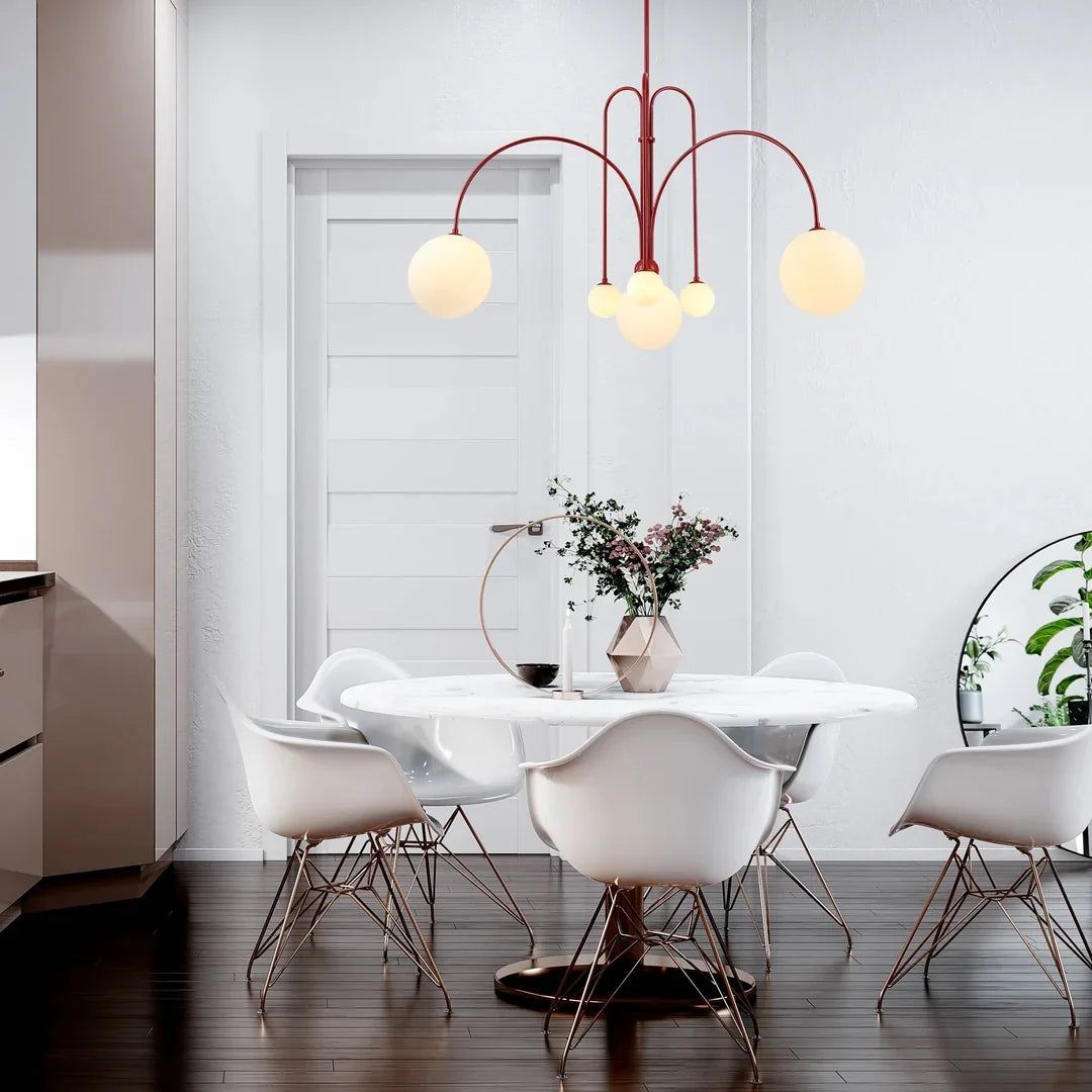 Bright red multi-arm chandelier with five white globe bulbs and curved metal arms