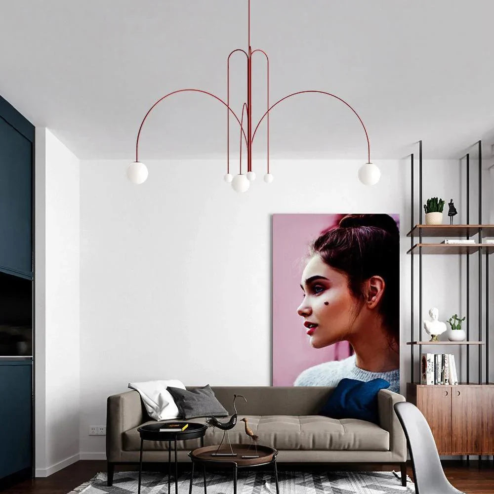 Red multi-arm chandelier with white globe bulbs and tall arched metal frame