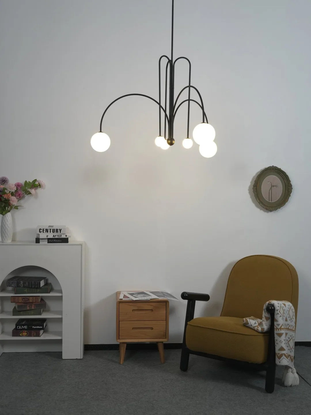 Black multi-arm chandelier with multiple small white globe bulbs and arched metal frame