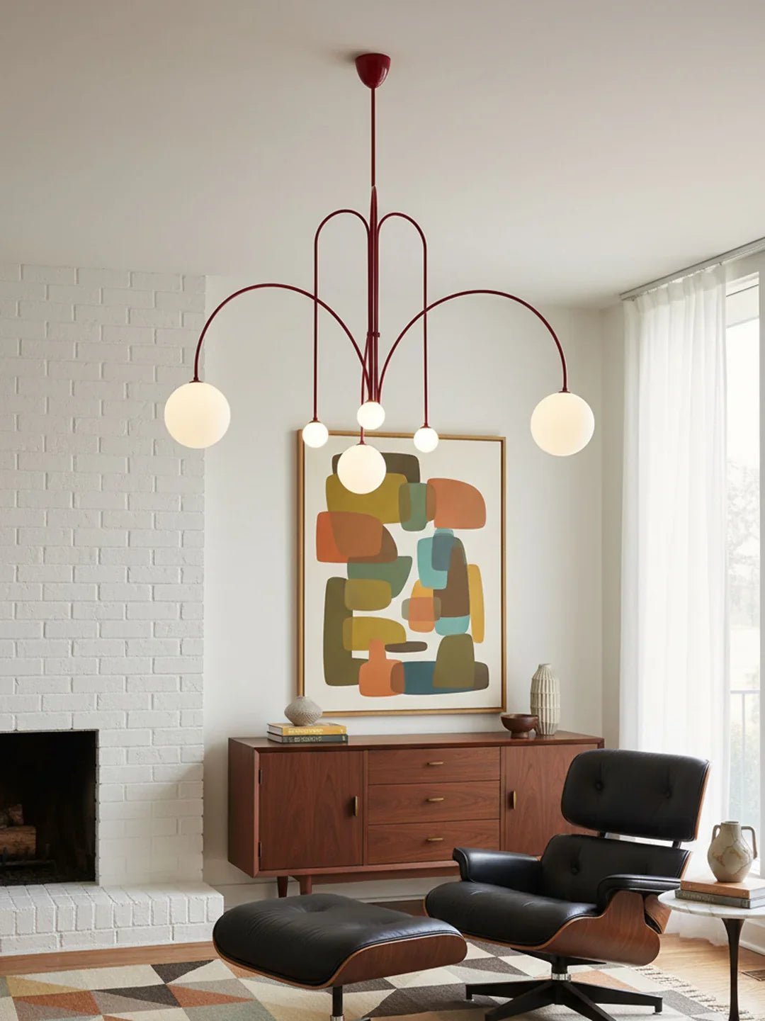 Multi-arm chandelier with red metal frame and round orb glass shades