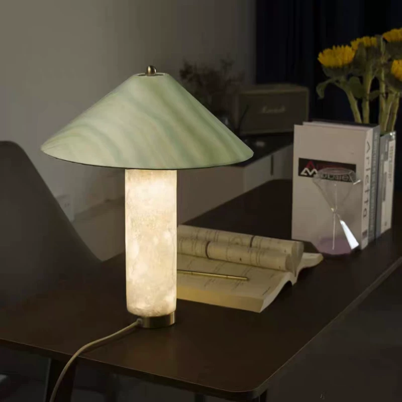 Alabaster column table lamp with green glass shade and warm-lit column