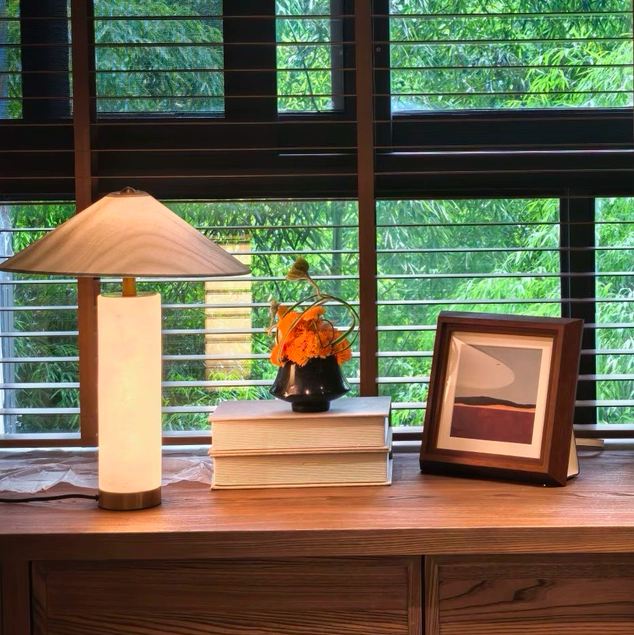 Column table lamp with green-tinted shade and translucent alabaster body