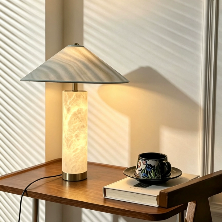 Green-tinted shade column table lamp with brass accents and glowing alabaster