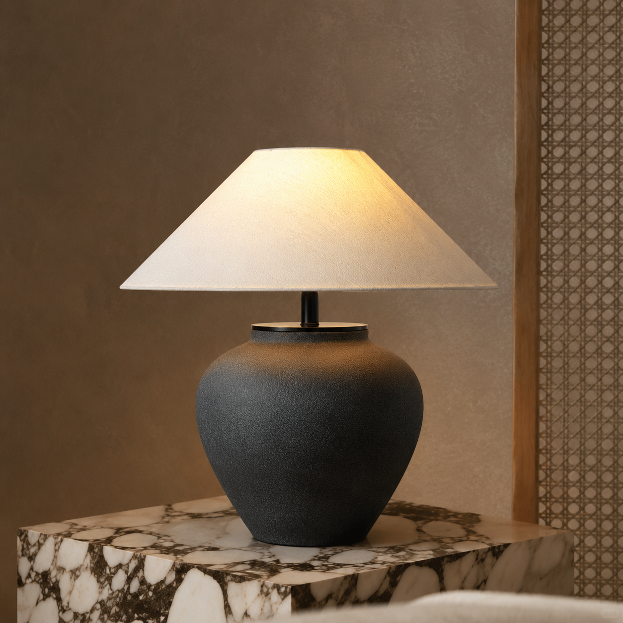 Ceramic table lamp with dark ceramic vase base and beige fabric drum shade